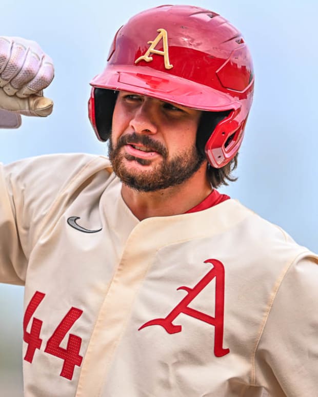 Razorbacks catcher Parker Rowland with first base coach Bobby Wernes after an RBI single in the sixth inning against Alabama.